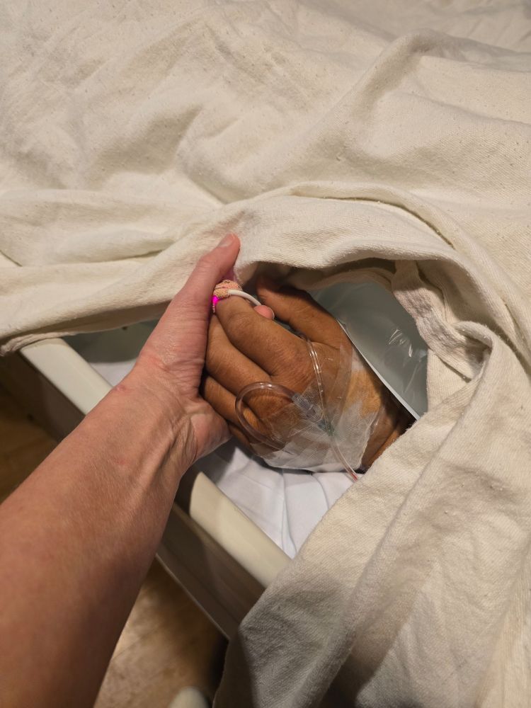 Holding my dying friend's hand at the hospital 
