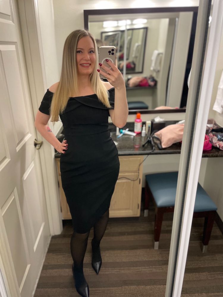 Blonde MILF wearing a black, off-the-shoulder dress