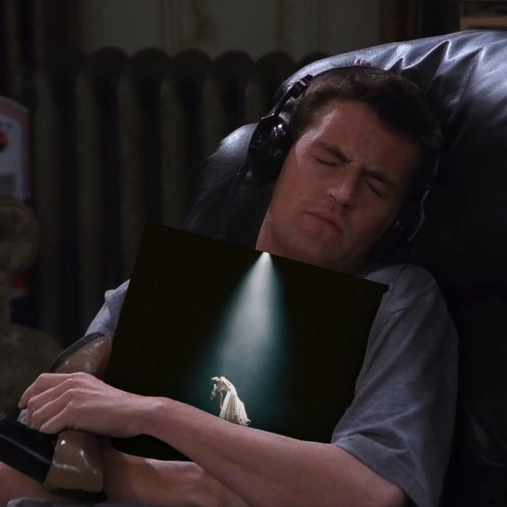 A custom meme of Chandler Bing from "Friends" holding Arianna Grande's "eternal sunshine deluxe: brighter days ahead" album. He's deep in his feelings.