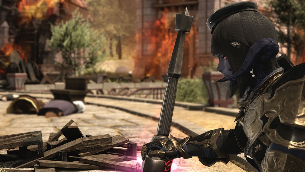 The same woman looks up a little. In the distance is destruction and fire.