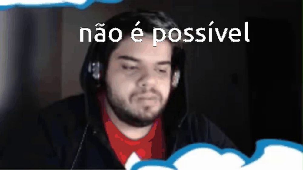 a man wearing headphones is sitting in front of a computer screen with the words não e possivel written above him