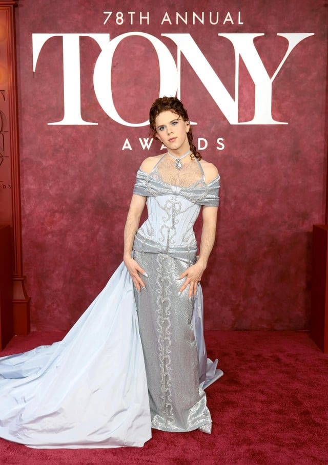 Tony winner Cole Escola, in a beautiful silver dress and with a curly updo