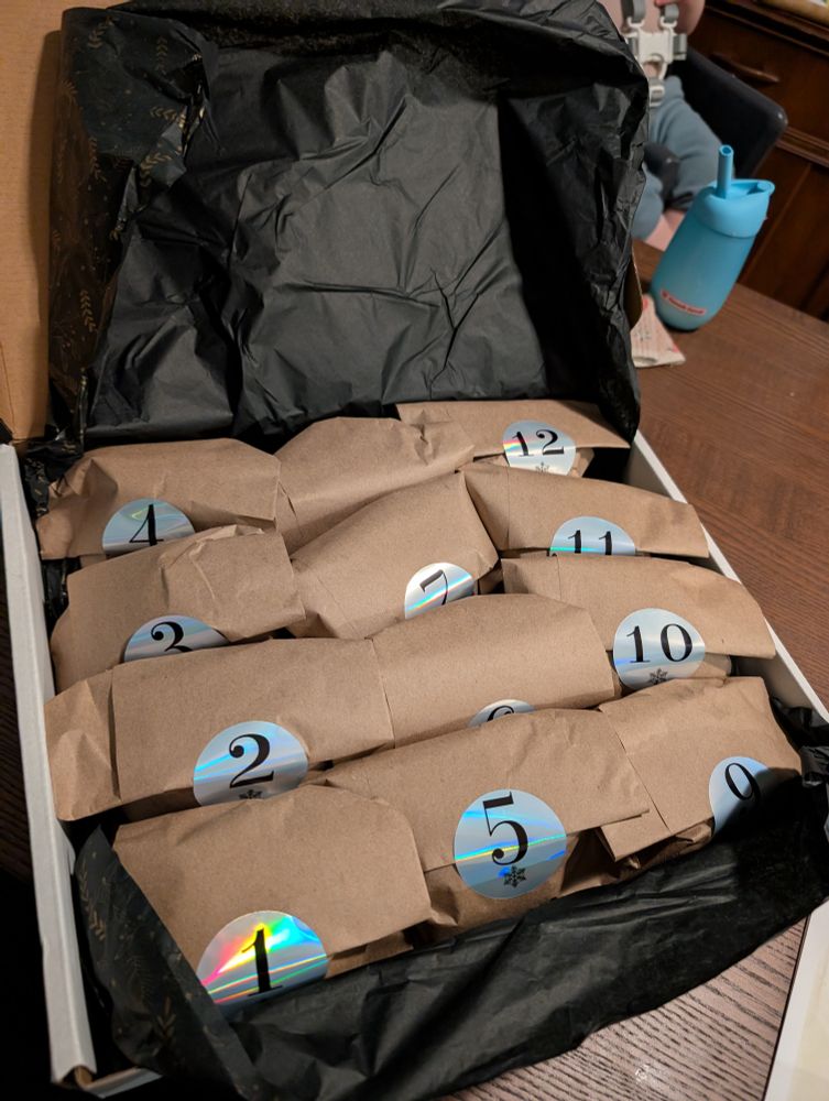 a box with numbered paper bags of wool
