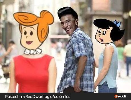 A meme parodying the “distracted boyfriend” image shows a man with the face of Red Dwarf character Cat turning to admire Wilma Flintstone, while his shocked girlfriend, Betty Rubble, looks at him disapprovingly.