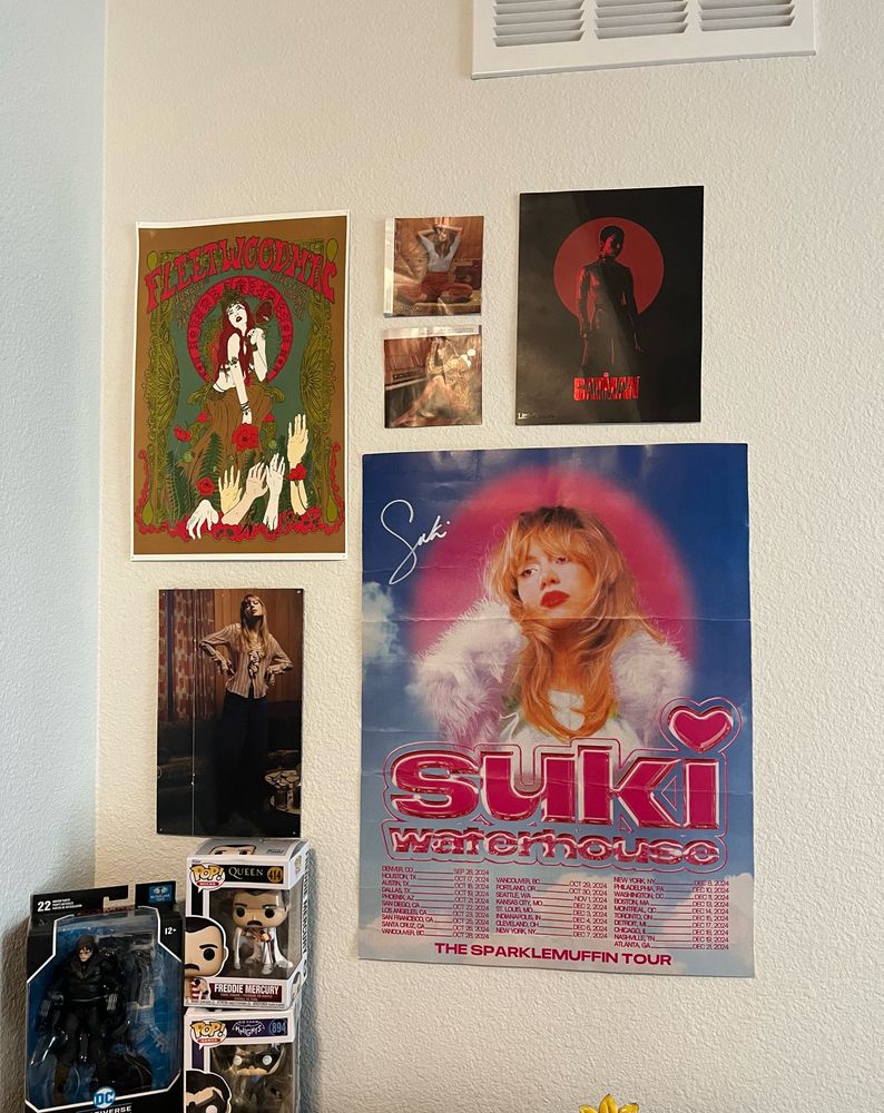 posters hanging on a wall: fleetwood mac, 3 taylor swift, batman, & suki waterhouse 