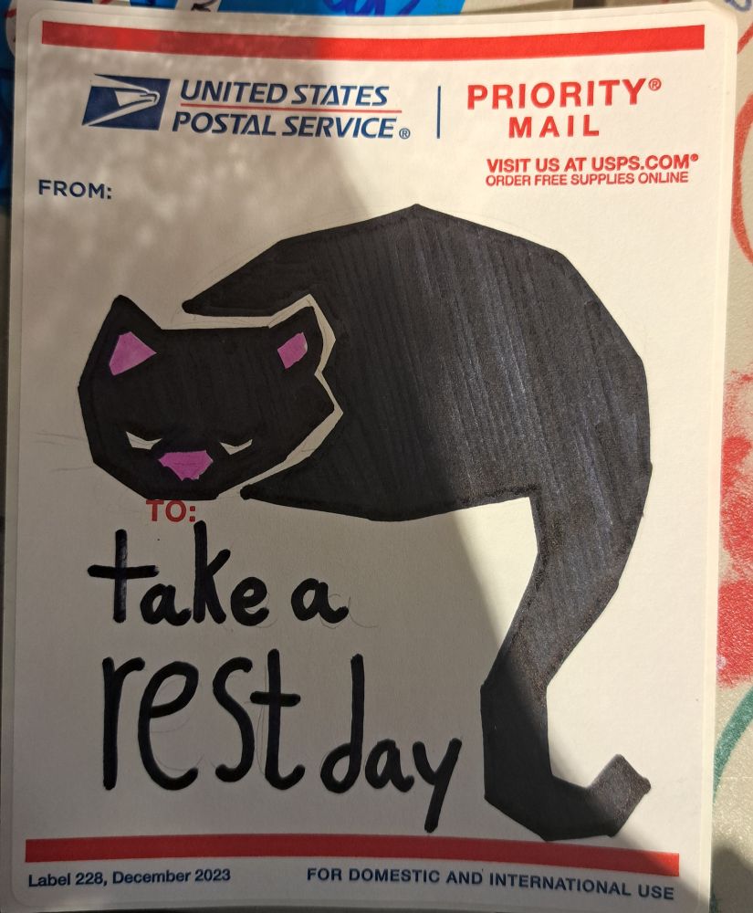 A marker drawing on a USPS postal label. The drawing depicts a black cat sleeping. Caption: take a rest day.