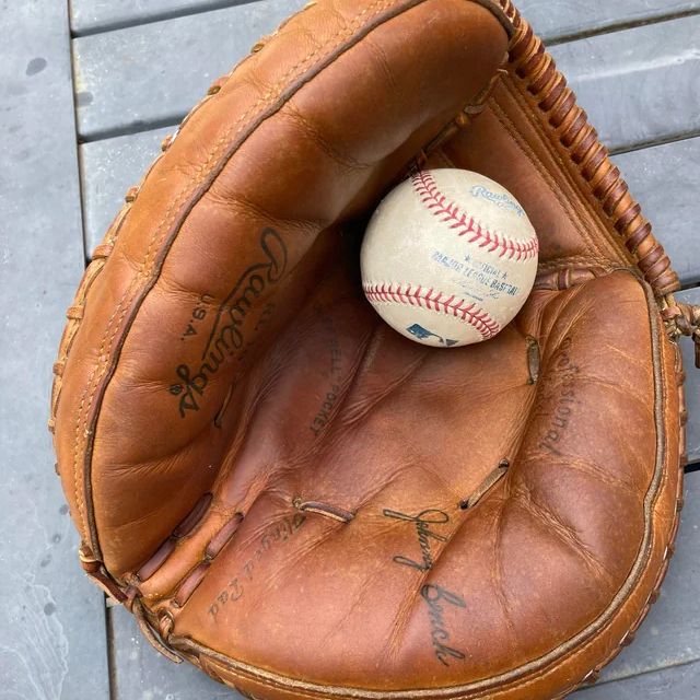 Rawlings catcher’s glove with a baseball in it.