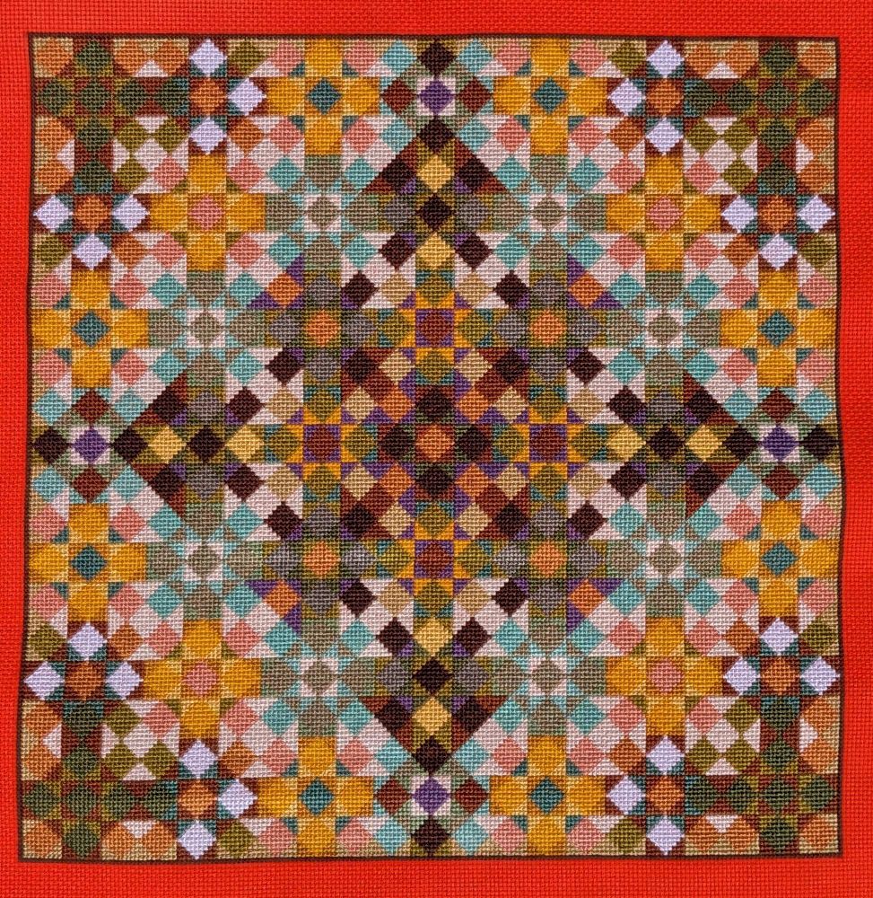 Full coverage cross stitch on bright orange aida. The colors are primarily golds, greens, and browns, with purples for accent. The pattern uses diamonds and triangles to form a geometric quilt pattern or kaleidoscope pattern effect.