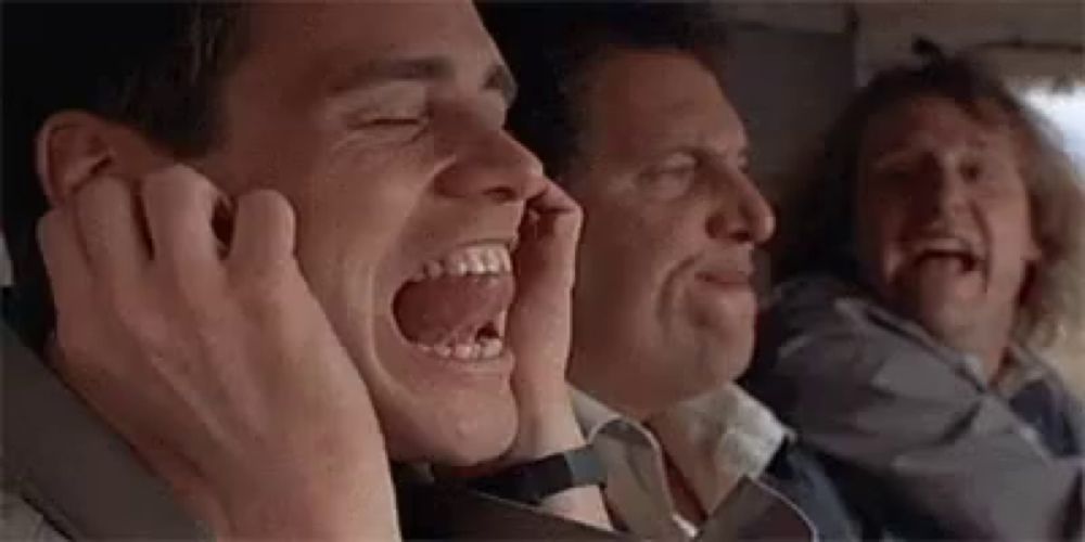 a group of men are sitting on a plane with their mouths open and screaming .