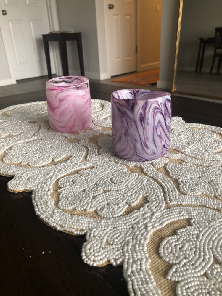 Two handblown drinking glasses from a glassblowing class I took with a lovely client, one a swirly pink and white, the other a swirly purple and white.