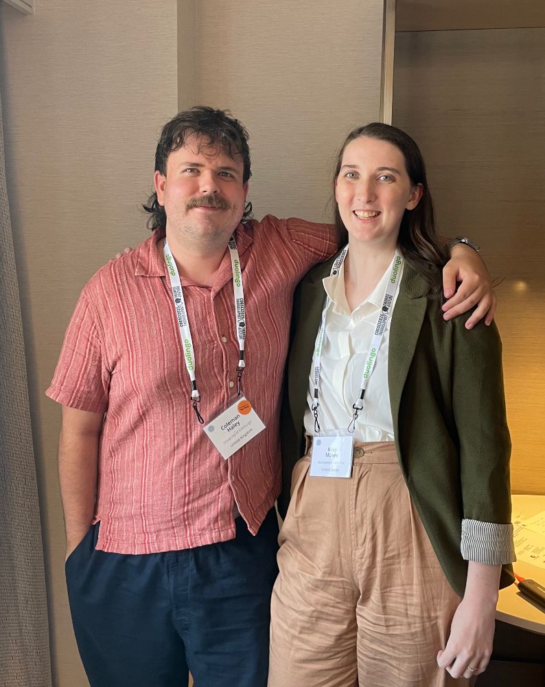 Kiley stands next to a fellow conference participant. 