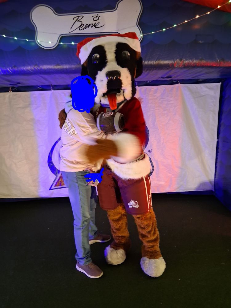A woman is sharing a loving embrace with a dog
