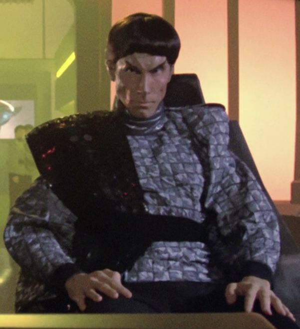 A Romulan commander (Anthony James) trying to look dangerous with a poofy bowl cut and quilted silver jacket with massive shoulder pads. From the Star Trek TNG episode "The Neutral Zone."