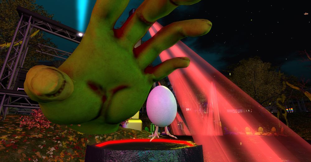 An avatar is an egg with chick legs standing under a giant sized green hand reaching to grab it.