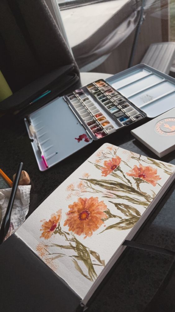 Water coloring flowers near the ocean.