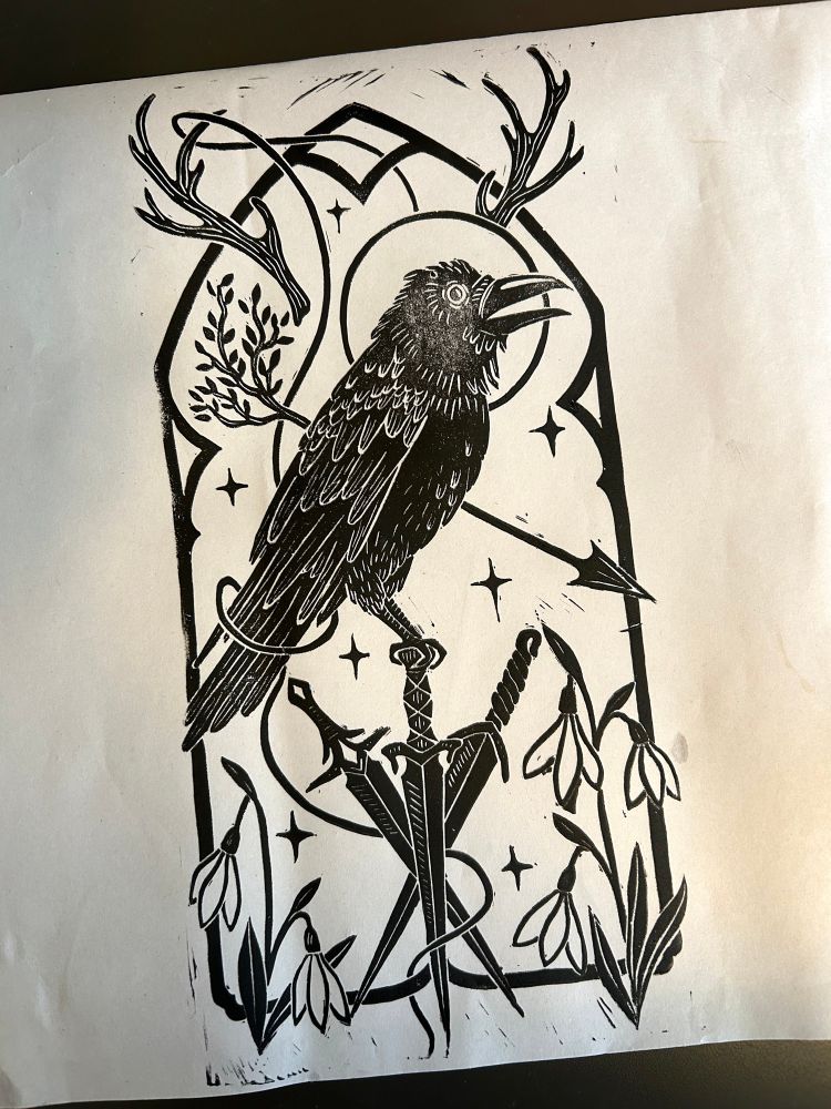 A picture of a black and white linocut block print of a raven perched on three daggers centered in a gothic archway. There is an arrow transforming into a tree behind the raven, snowdrops at the base of the arch, and antlers above the raven. It’s inspired by Vaxildan, a character from Critical Role. 