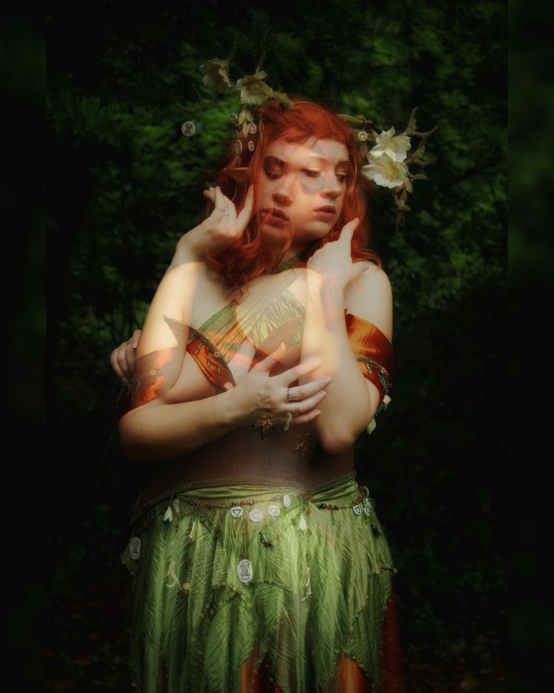 A double-exposure photo of Sophie dressed in cosplay as Keyleth. It has a dreamy haze and a dark leafy background