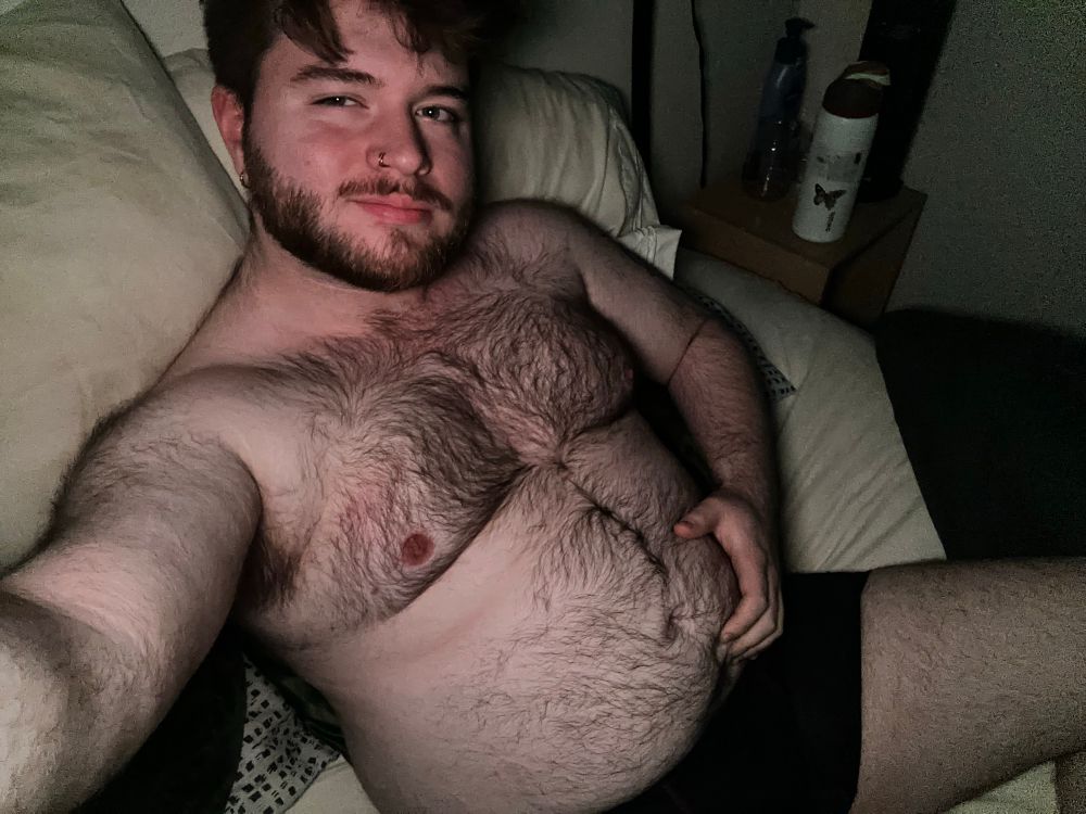 In my boxers laying in bed, angle from slightly above, hand on my belly 