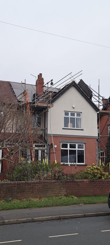 House showing solar panels being installed on the roof
