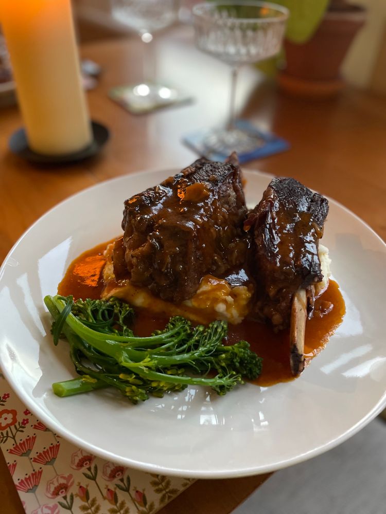 Braised short ribs on mashed potato with a red wine sauce and tenderstem broccoli
