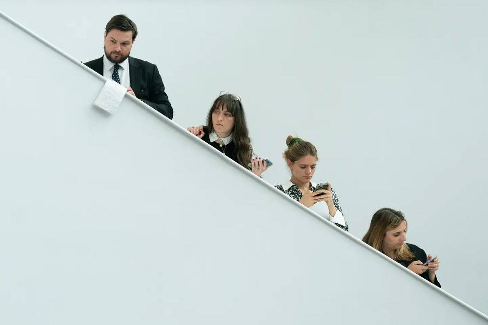 Chris, Chloe Chaplin, Lara Spirit and Jess Elgot stand on a white staircase to listen (more or less) to Keir Starmer
