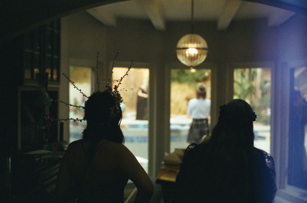 A back view of my mother and sister watching our first look photos