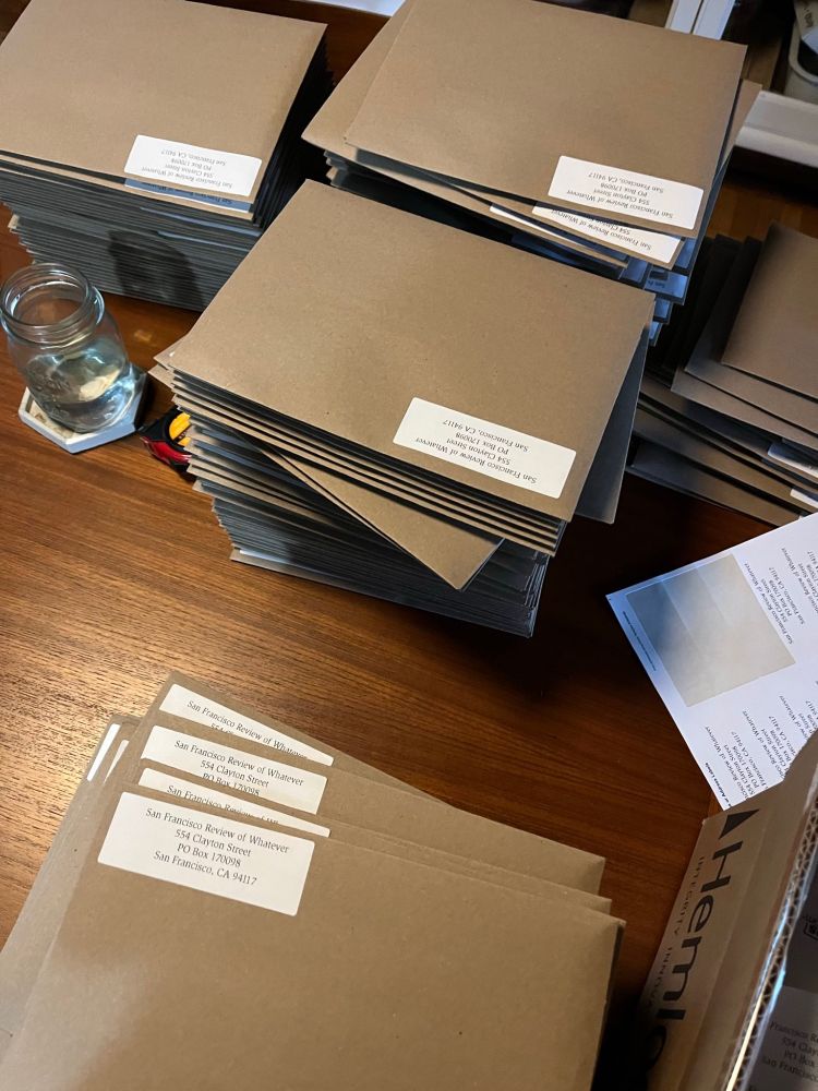 Stacks of Kraft paper envelopes getting stuck with address stickers 