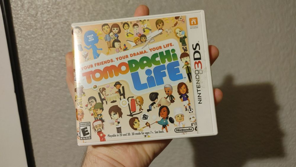 Me holding up my copy of Tomodachi life for the Nintendo 3ds