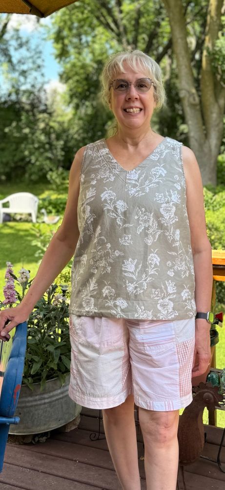 Woman on a summer day, wearing a handmade flowered top and quilted shabby chic shorts. 