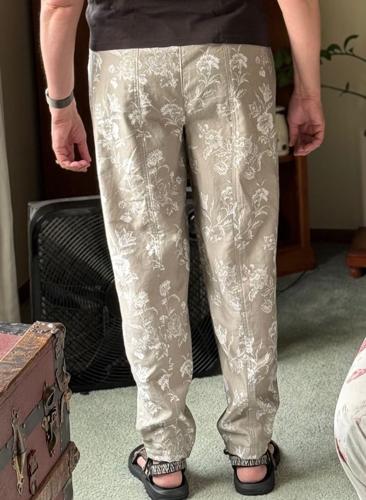 Woman wearing flowered pants - back