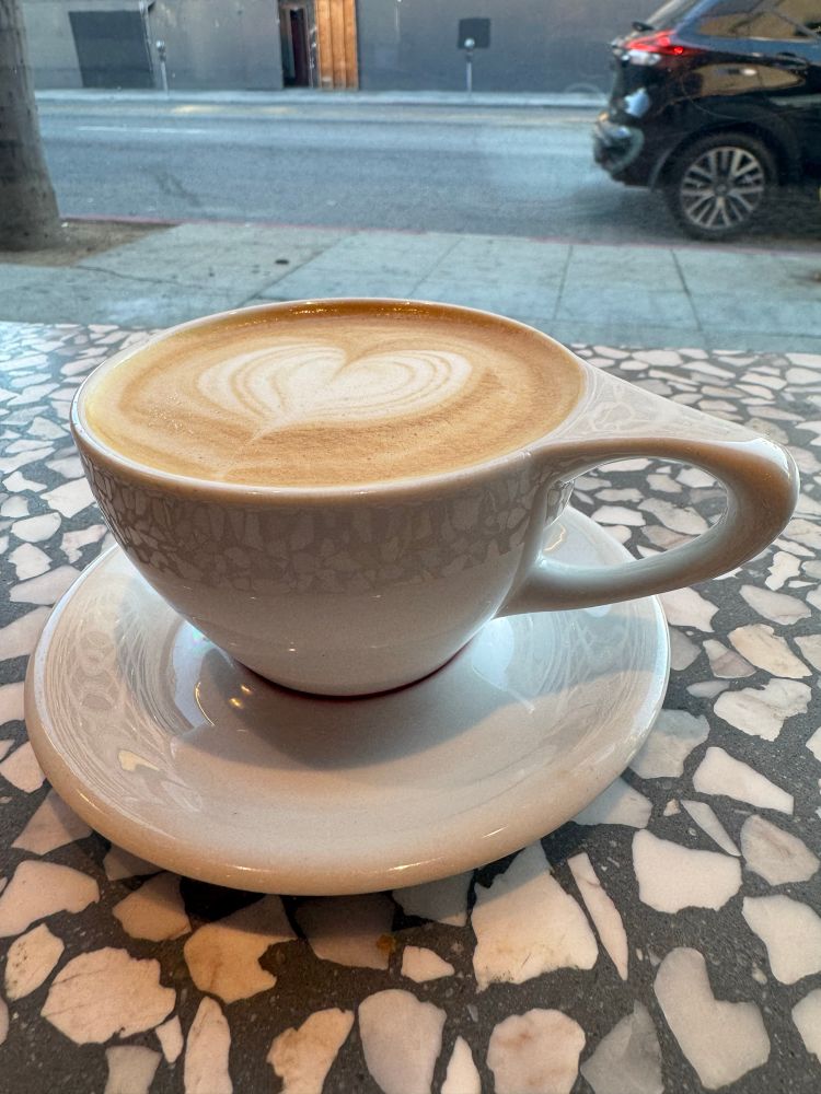 A latte near a window showing traffic 