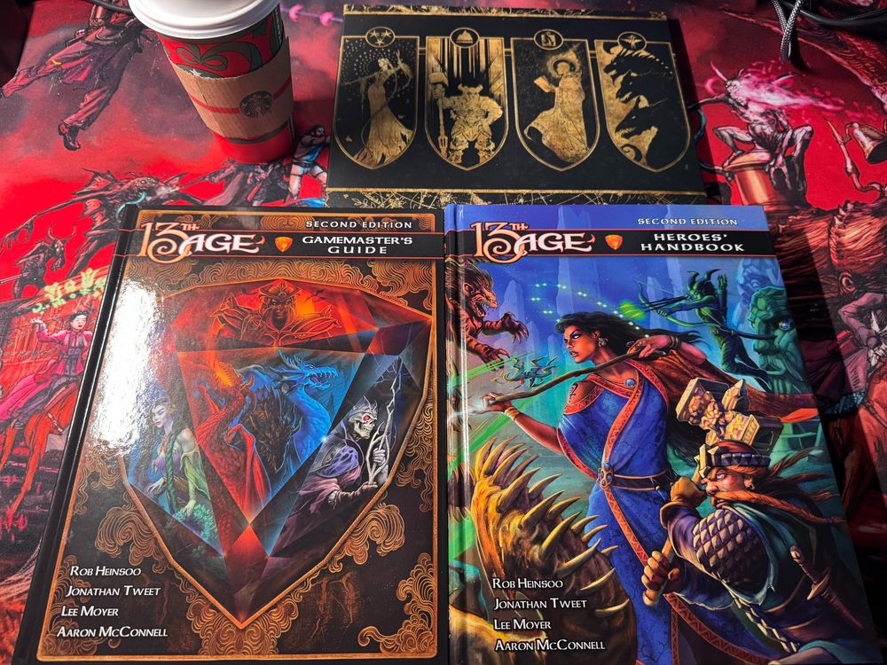 13 Age Second Edition Players Book, GM's book, GM Screen and a Starbucks coffee all on a Haunted West mouse pad