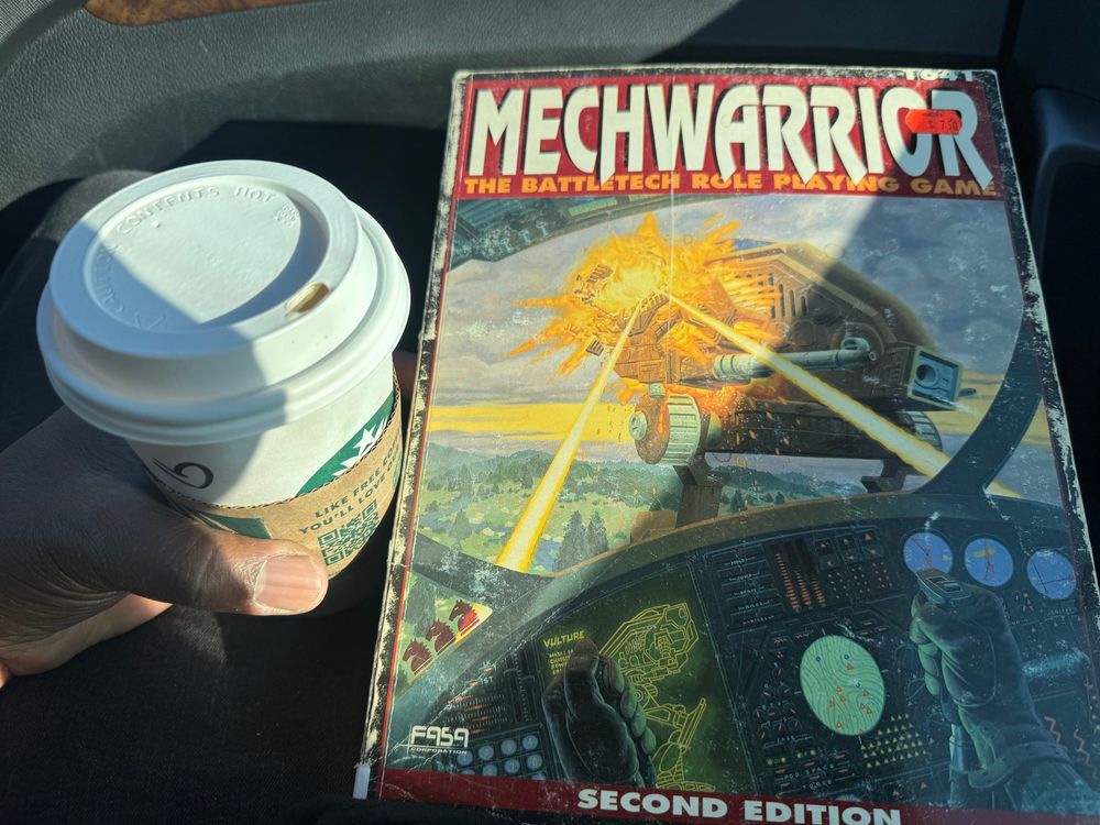 Mechwarrior 2E cover next to a Starbucks coffee