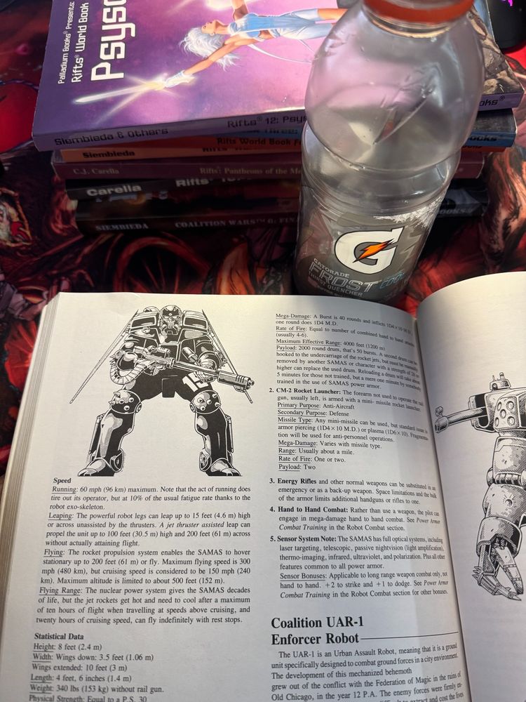 The Rifts corebook open to the Coalition Samas page states with six other books behind it. A nearly empty bottle of Gatorade is nearby. 