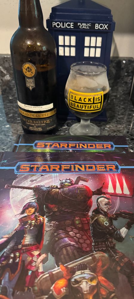 Grande Cuvée Porter Baltique​ pour into a Black is Beautiful beer glass behind the Starfinders cover book