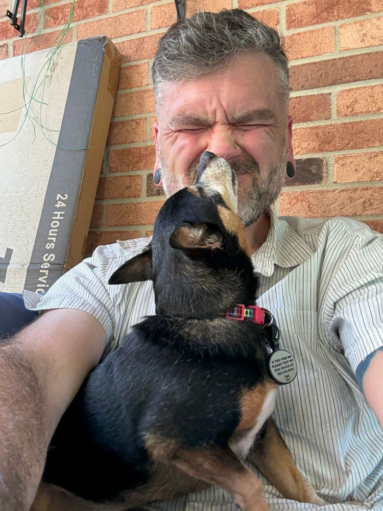 Peaches sitting on my lap licking my nose