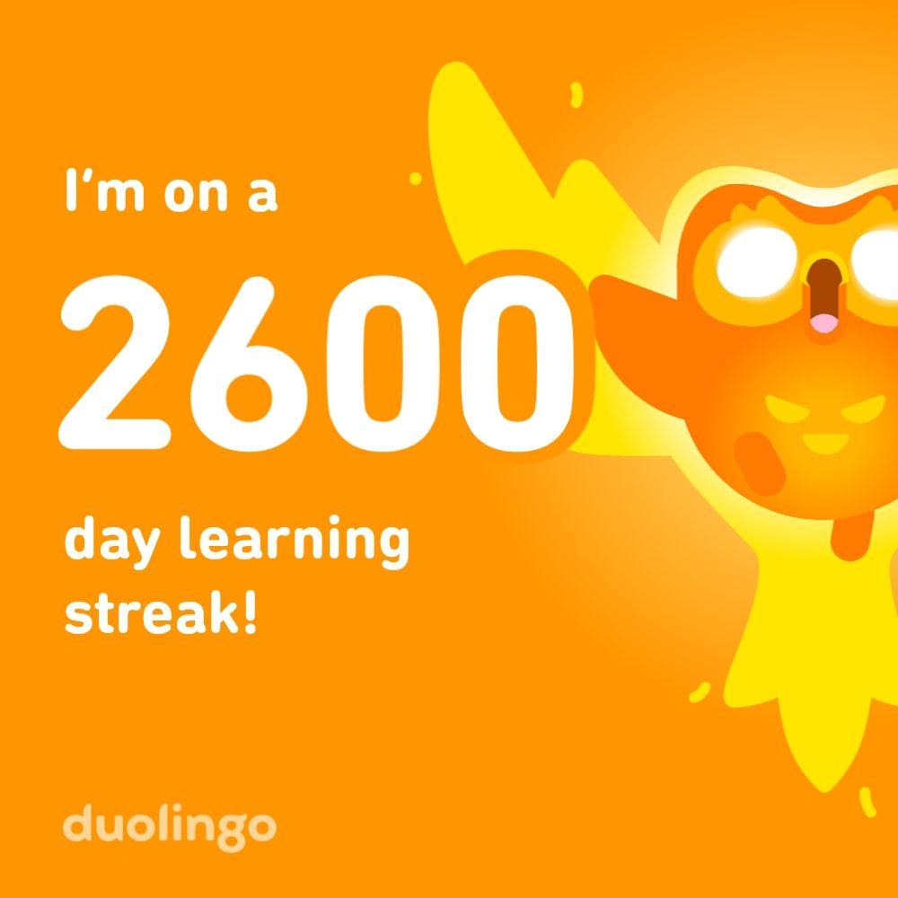 Duolingo streak image with orange background, a flaming duo owl on the right with its mouth open in a celebratory pose. the text says 'I'm on a 2600 day learning streak!' 