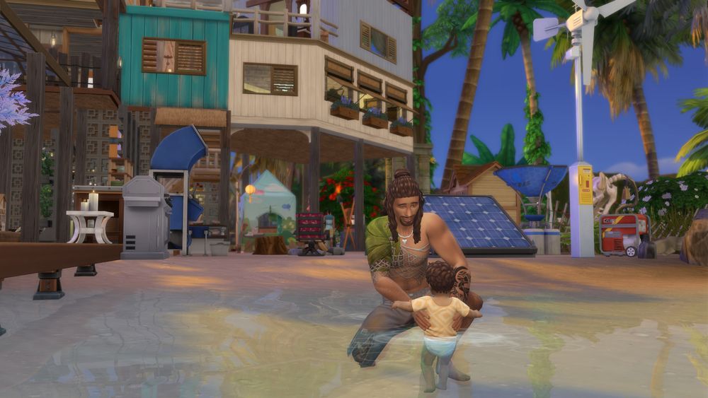 A screenshot of the Sims 4 showing my castaway family. Pictured is my merman Eli, with his mermaid daughter Melody. He is letting her experience the water for the first time as an infant. They are on their deserted island home away from any sort of populace or amenities. Behind them you can see some utilities to produce water and electricity, a chicken coop, along with the home the small family live in. The sky is blue and the island tropical. 