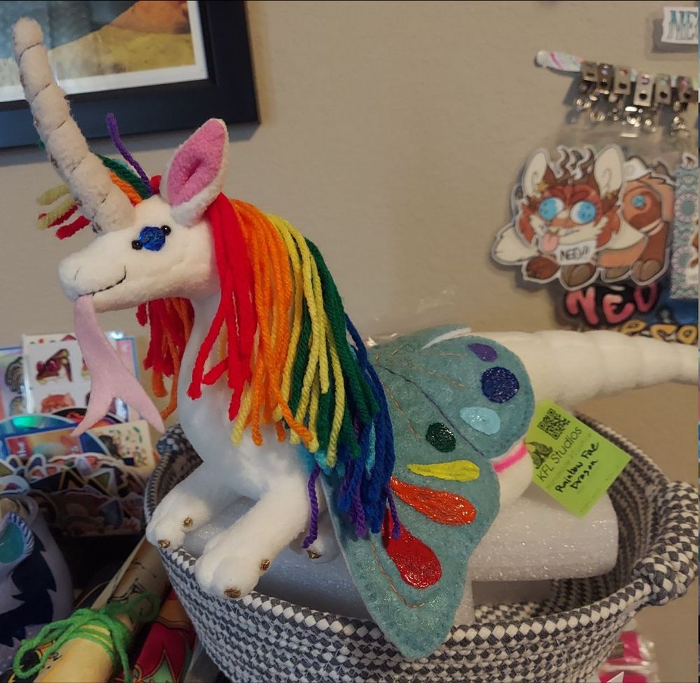 large white fae dragon plush with rainbow details