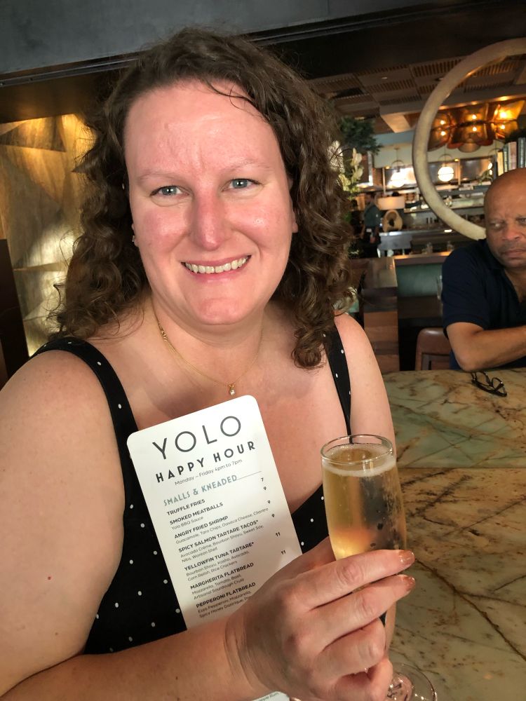A picture of me holding a menu from the Ft. Lauderdale restaurant YOLO on the last day of my job as a lawyer and first day of ATP/CTP. 