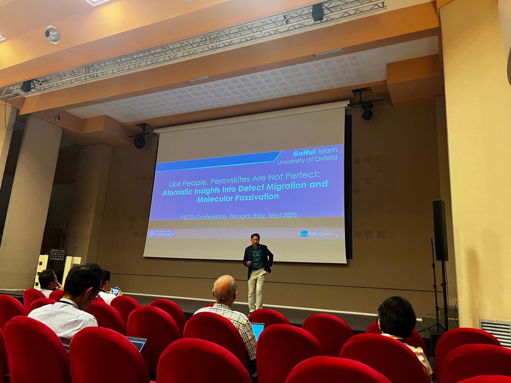 Saiful Islam in front of his title slide on screen, like people, perovskites are not perfect