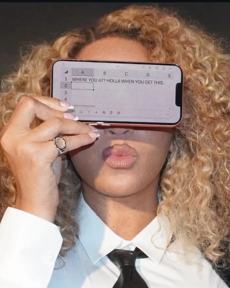 beyoncé holding up a phone where she’s been texting in microsoft excel 