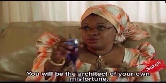 african auntie in orange and cream traditional garb holding a glass of red wine, warning you that you will be the architect of your own misfortune 