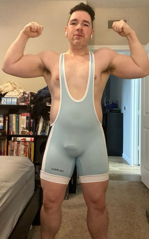 Me doing a double bicep flex in a singlet. 
