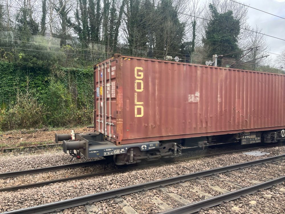 A rusty freight train with the word GOLD on the side