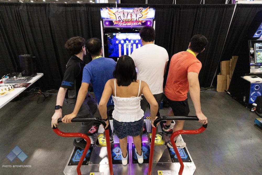 5 people simultaneously playing a DDR machine.