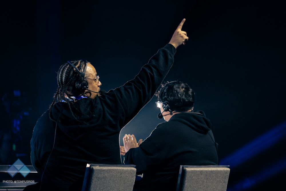 Photo of IFC Yipes turning to point to the crowd during his commentary in the Evo arena.
