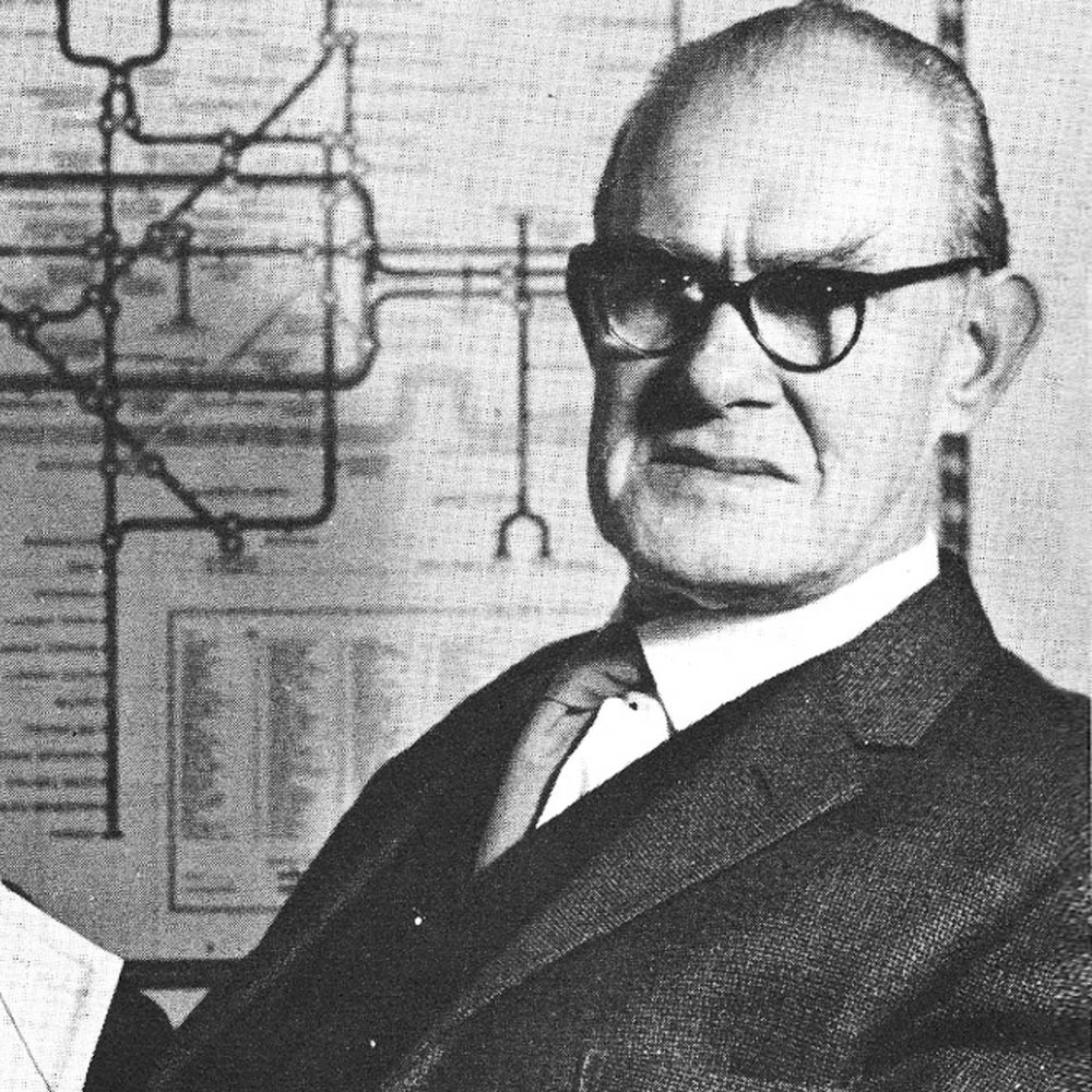 Photo of Henry Beck in front of his map of London's subway system.