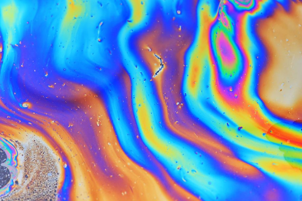 Rainbow colours of an oil slick on water