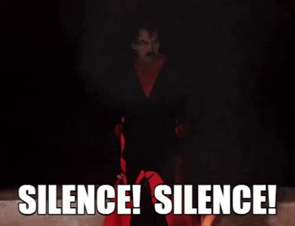 a man in a black suit is surrounded by red hands with the words silence silence written on them